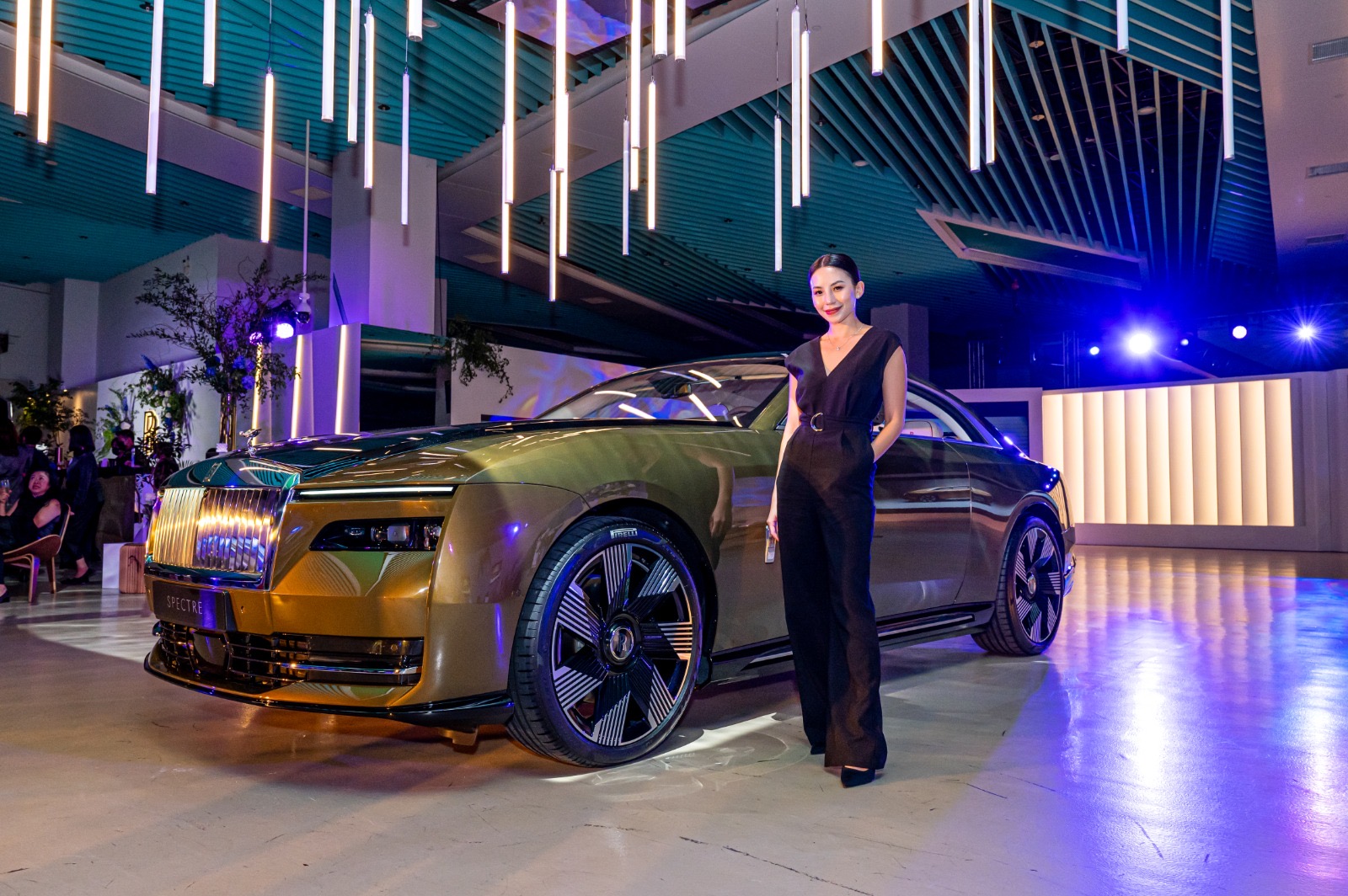 Fiona Loh beside a Rolls-Royce Spectre at an event